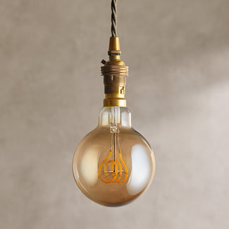 Large globe 4 watt LED edison style filament bulb with amber coating and B22 fitting