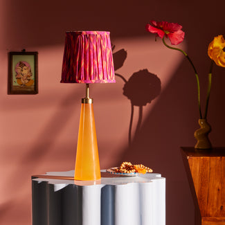 Cueva rechargeable table lamp in neon orange by Matthew Williamson