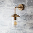 Curlew IP44 wall light in antique brass